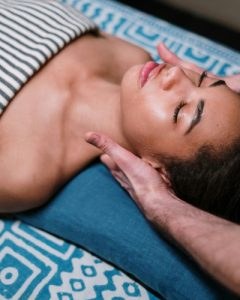 Client relaxing during a neck and shoulder massage